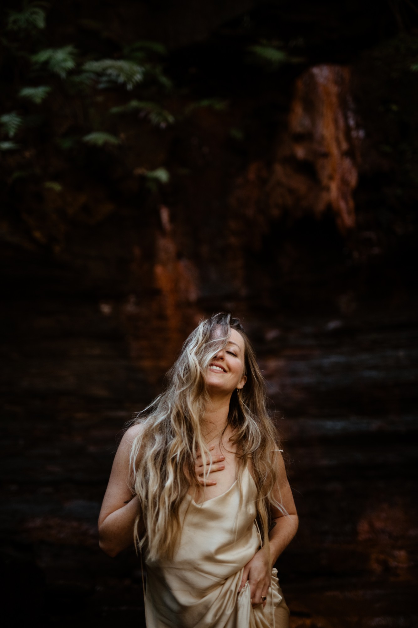 A woman with her hand on her heart, eyes closed and smiling